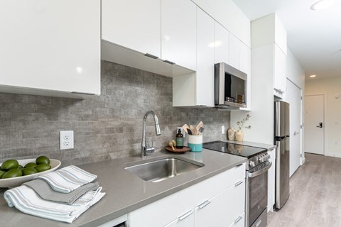 a kitchen with white cabinets and a sink