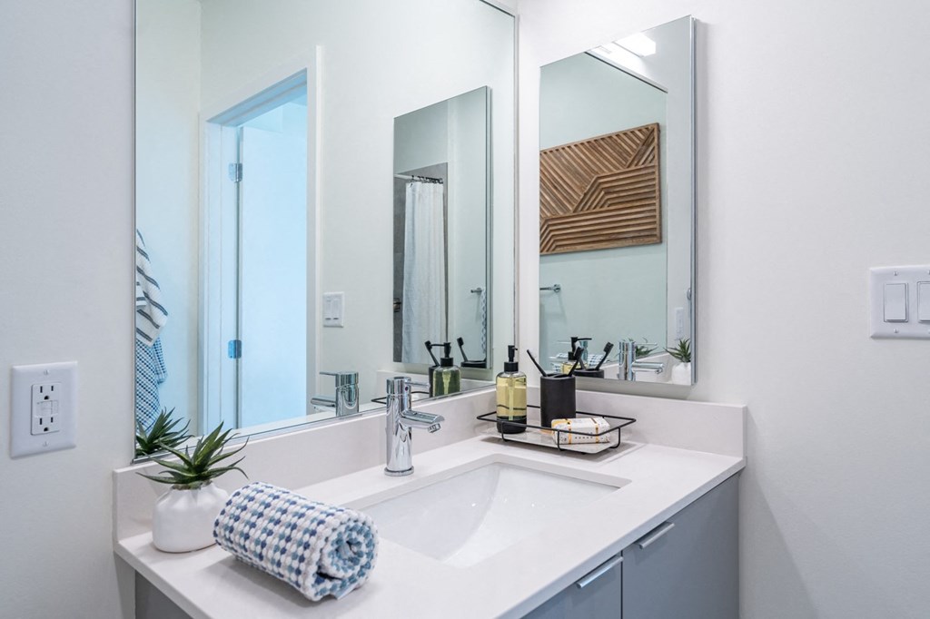 a bathroom with a sink and three mirrors at Union 346 Apartments, Massachusetts, 02143
