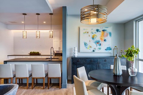 a dining room and kitchen with a table and chairs