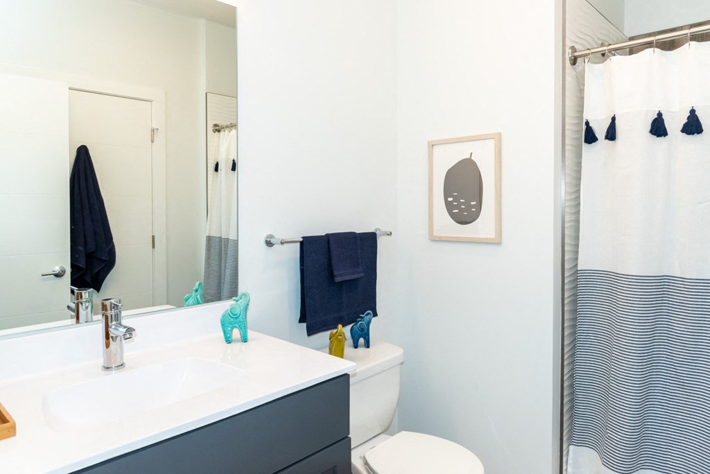 Model apartment bathroom with bright finishes