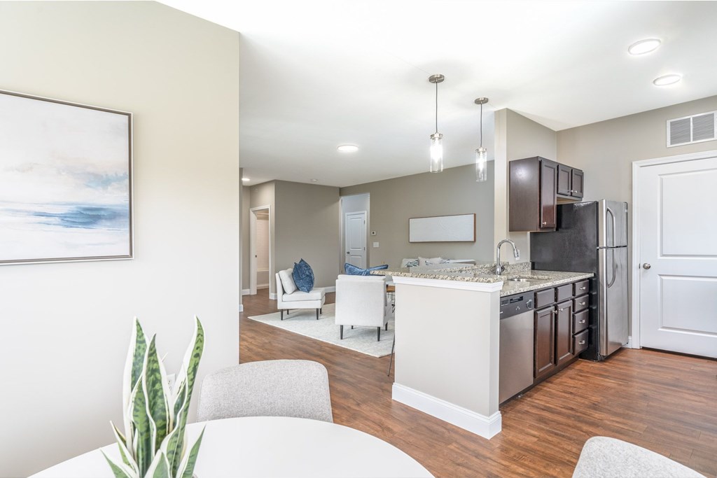 A modern kitchen with a white island and stainless steel appliances.