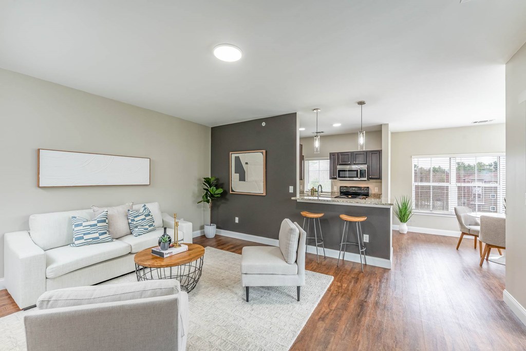 A living room with a white couch and a bar area.