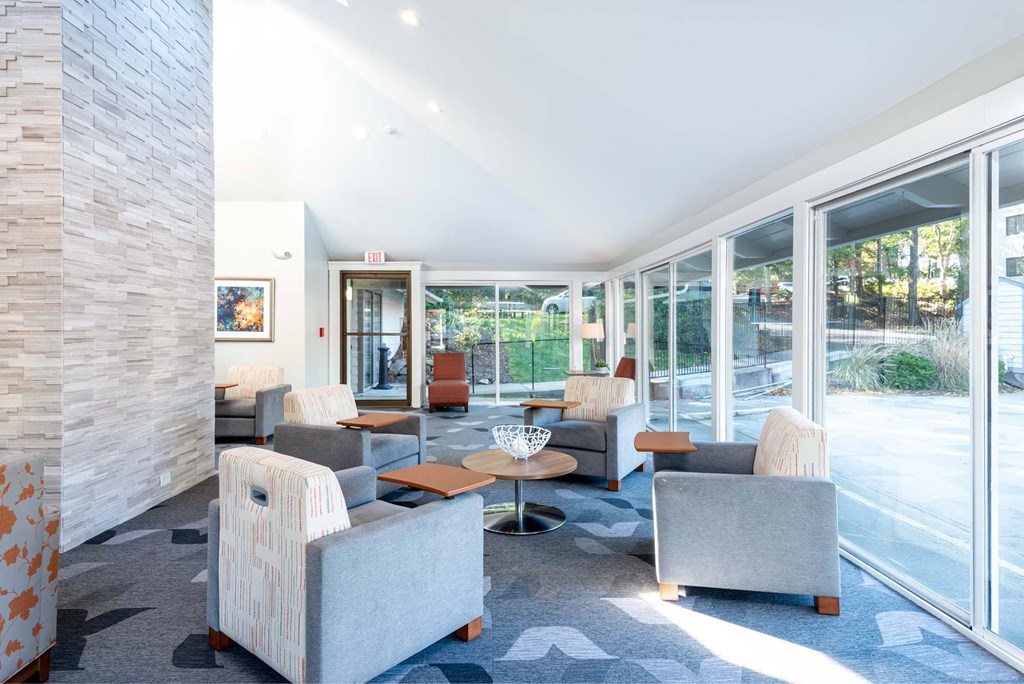 Tablet chairs at Weymouth Commons with a view of the pool