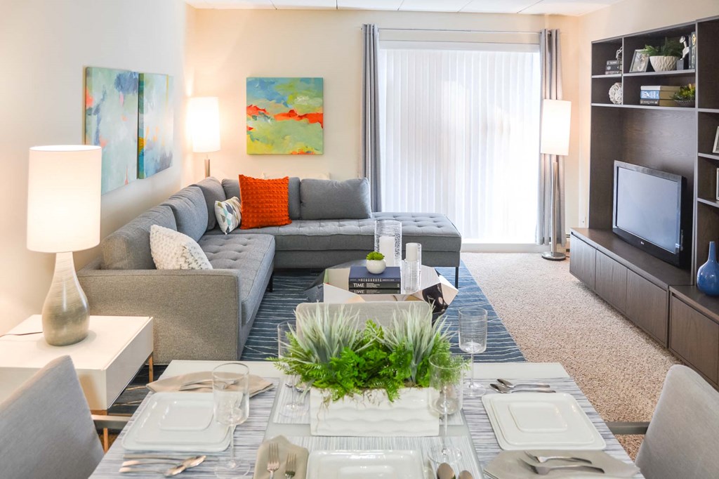 View of the living room and dining room at Weymouth commons with balcony doors