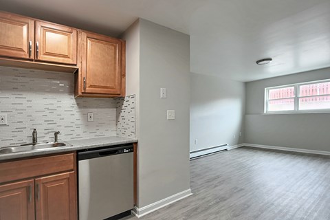 A kitchen with wooden cabinets and a dishwasher.