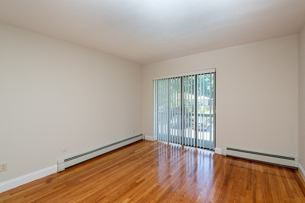 Quincy Commons one bedroom apartment with wood flooring and balcony