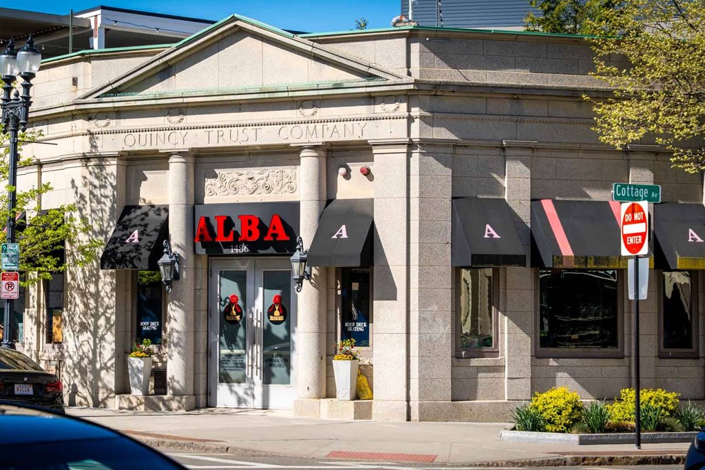A building with a red sign that says Alba.