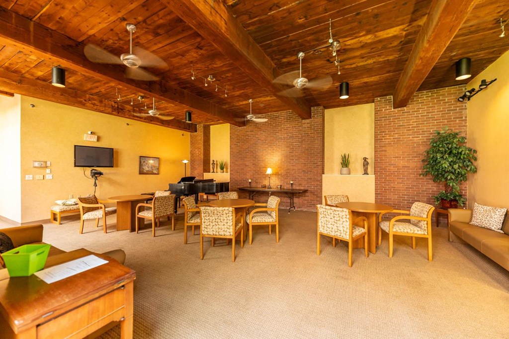 a large room with tables and chairs and a couch