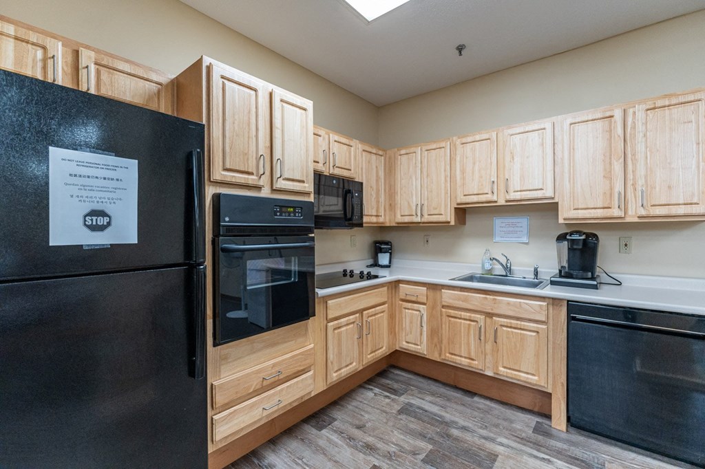 a kitchen with black appliances and wooden cabinets