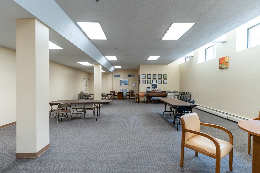 a large room with tables and chairs and chairs in it