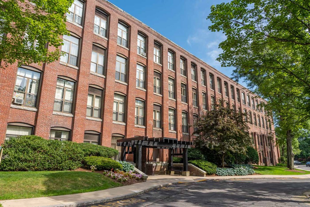 Andover Commons exterior near downtown a large brick building with a sidewalk in front of it