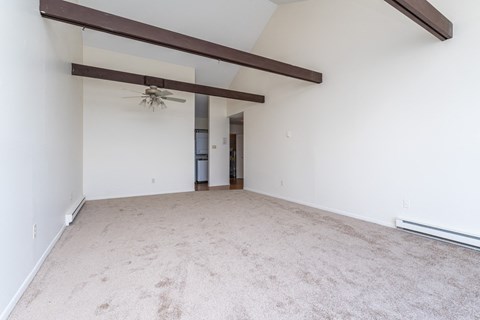 a bedroom with white walls and a ceiling fan