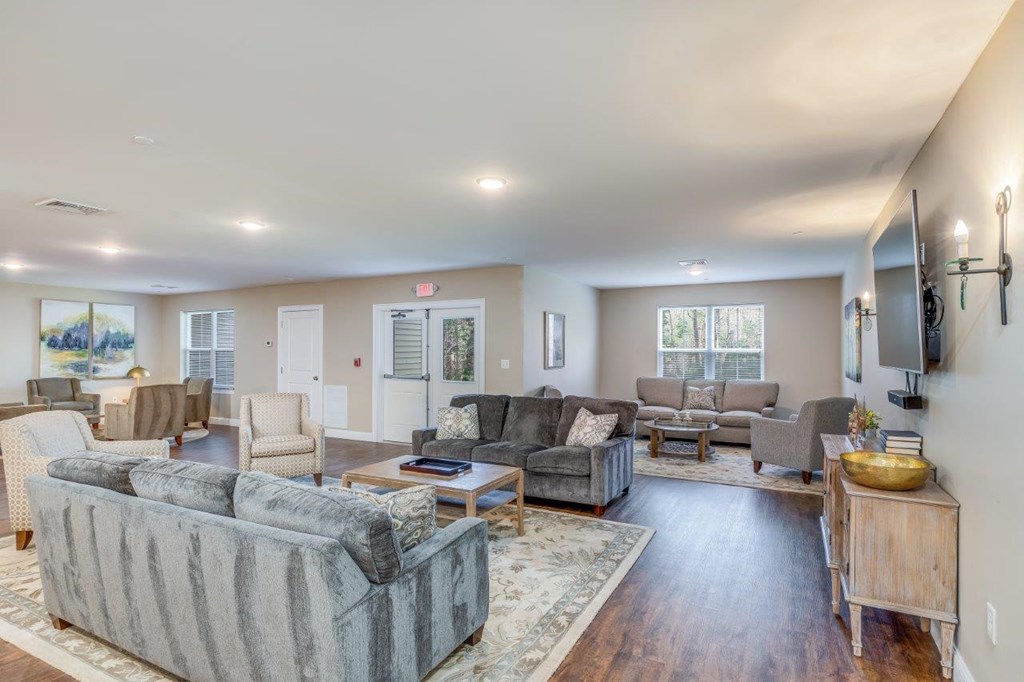 A bright and roomy common area filled with plush sofas and modern décor, creating a welcoming space for social events.