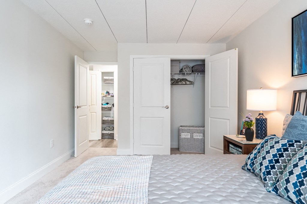 a bedroom with a large bed and two closets