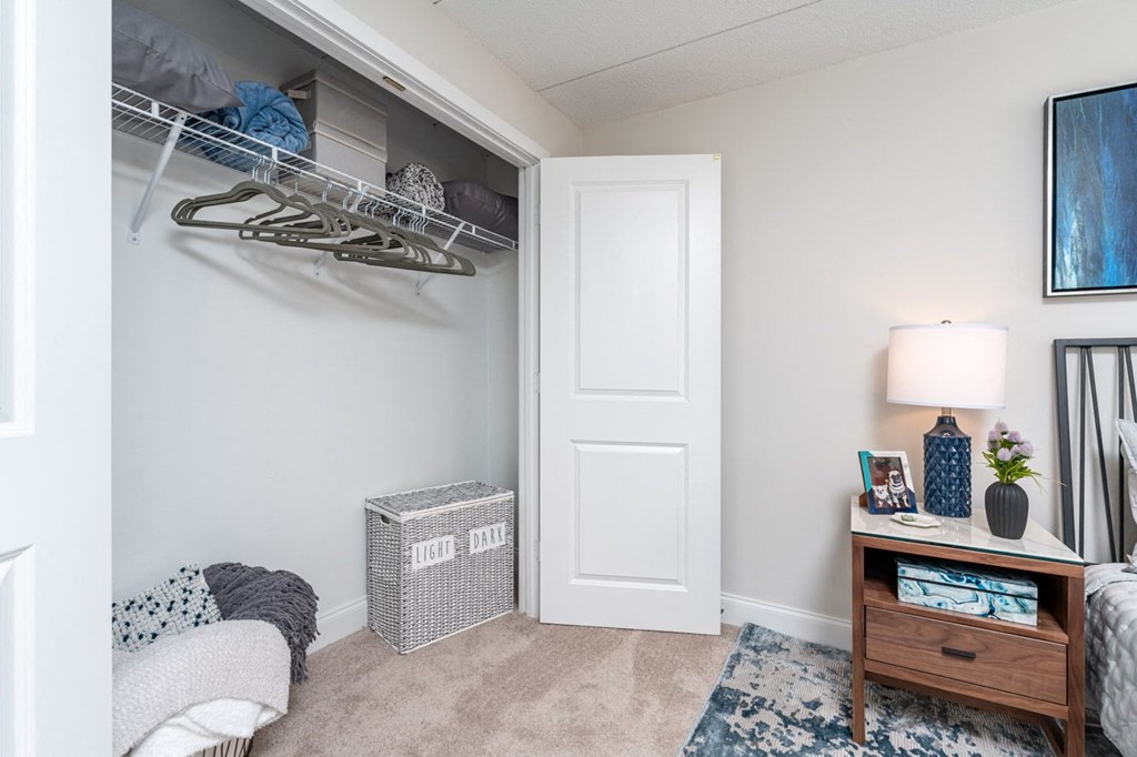 a bedroom with a closet and a desk with a lamp