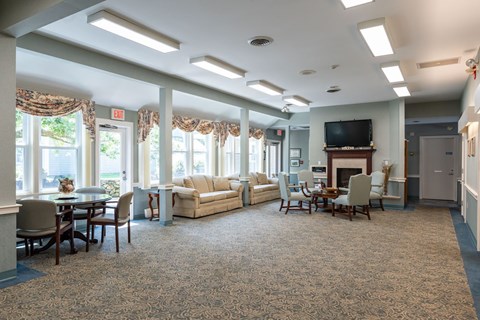 A spacious living room with a fireplace and a television.