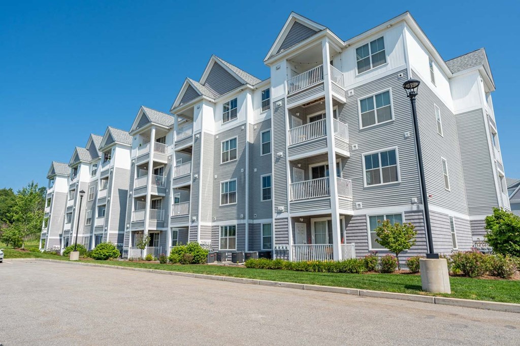 a row of apartment buildings with a street in front of them