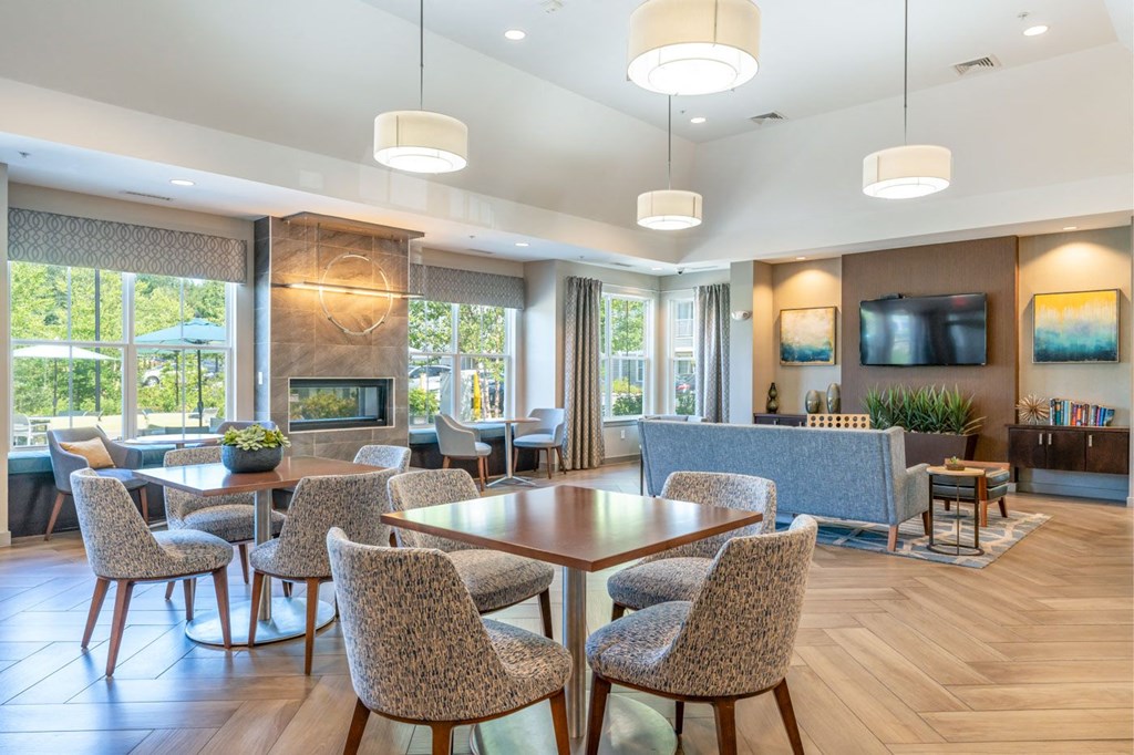 a living room with tables and chairs and a fireplace