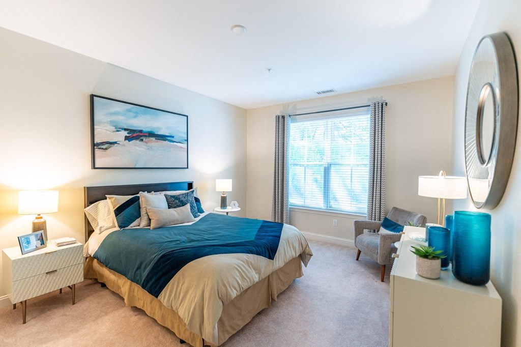 a bedroom with a large bed and a window