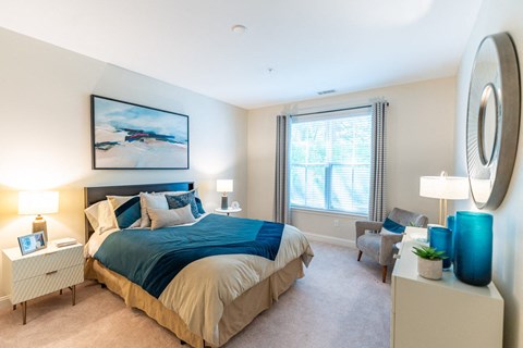 a bedroom with a large bed and a window