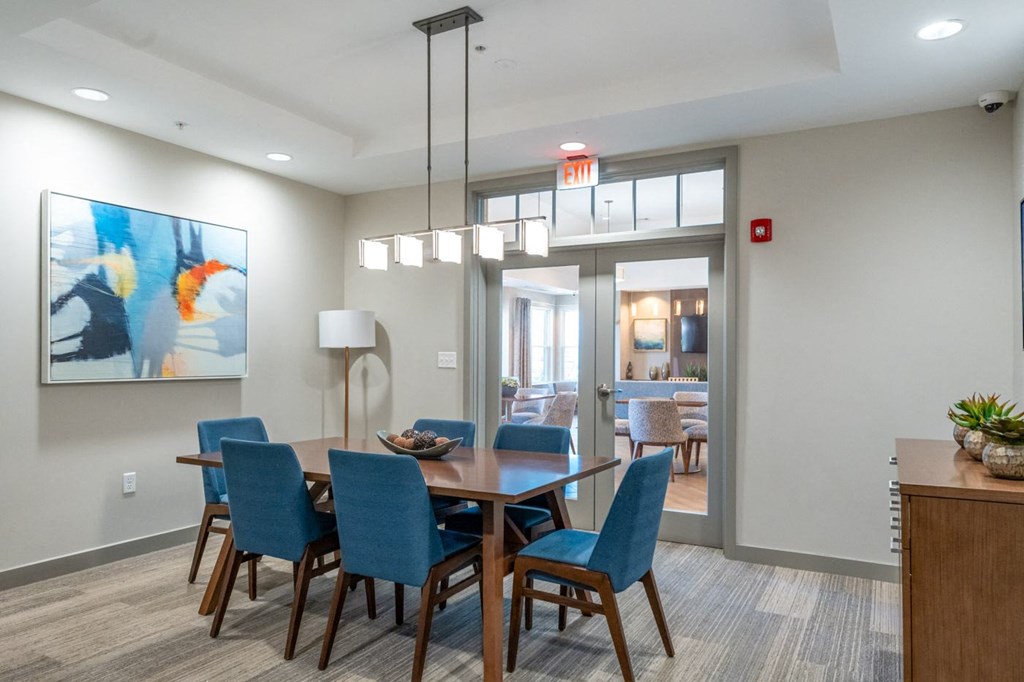 a dining room with blue chairs and a wooden table