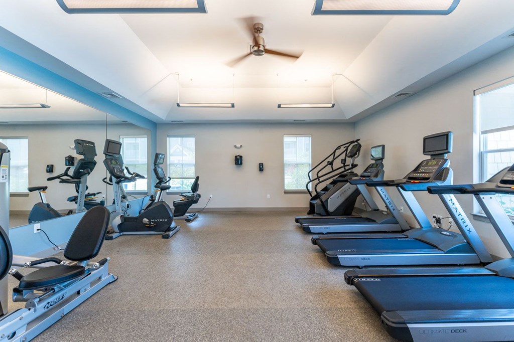 the gym with treadmills and ellipticals at the belmont shores apartments