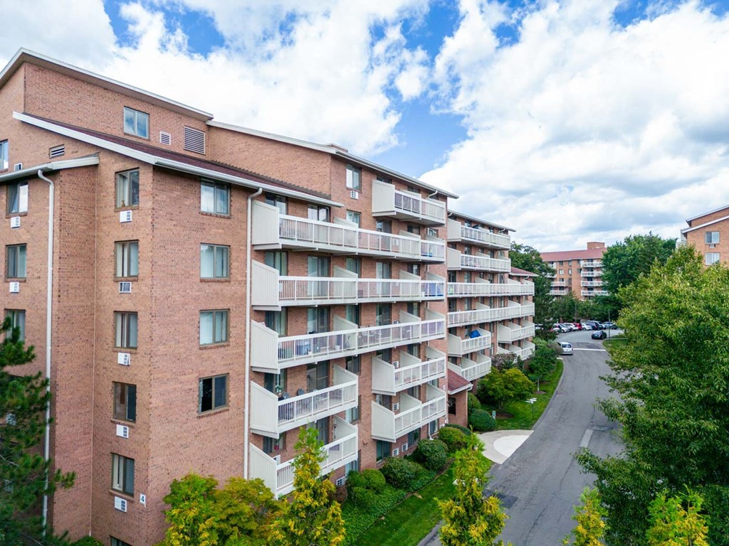 a view of an apartment building with a street in front of it
