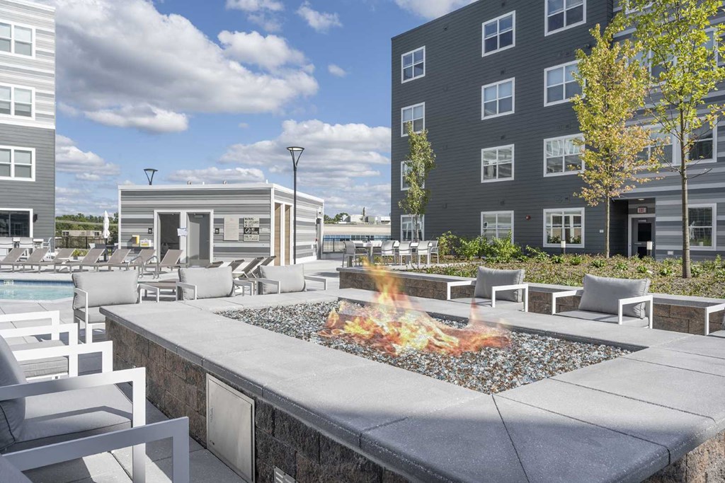 a firepit and lounge area at the flats at big tex apartments in san antonio