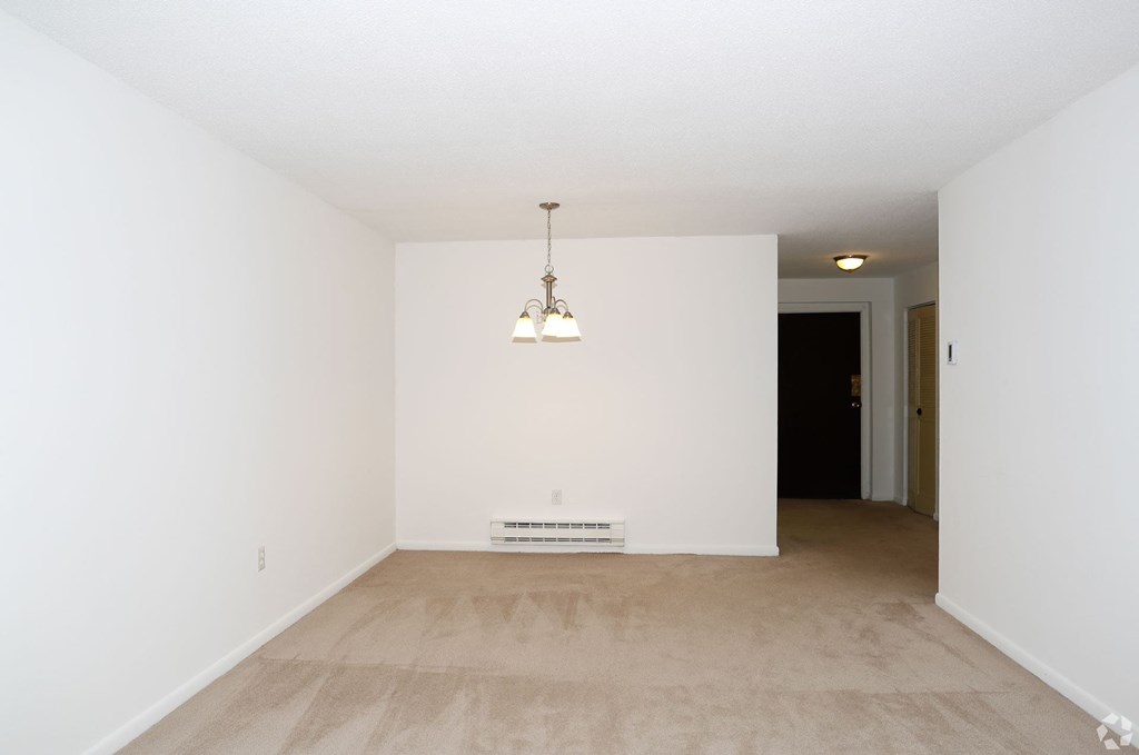A room with a light fixture and a white box on the floor.