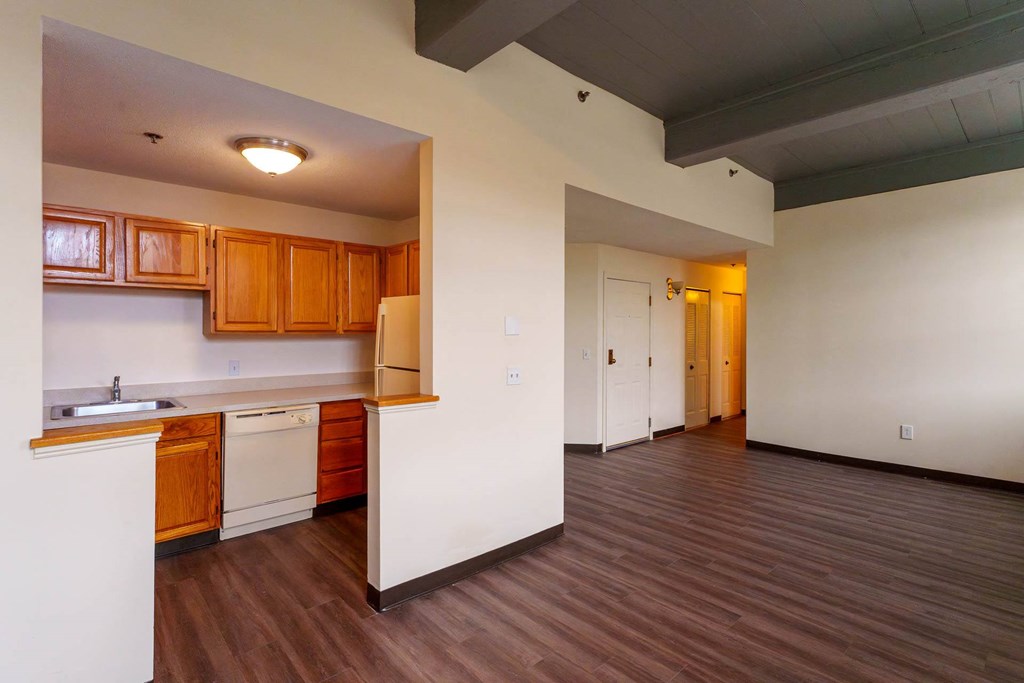 A kitchen with wooden cabinets and a white countertop.
