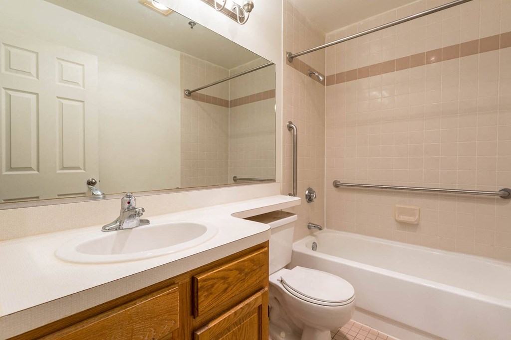 A bathroom with a white sink and a white toilet.