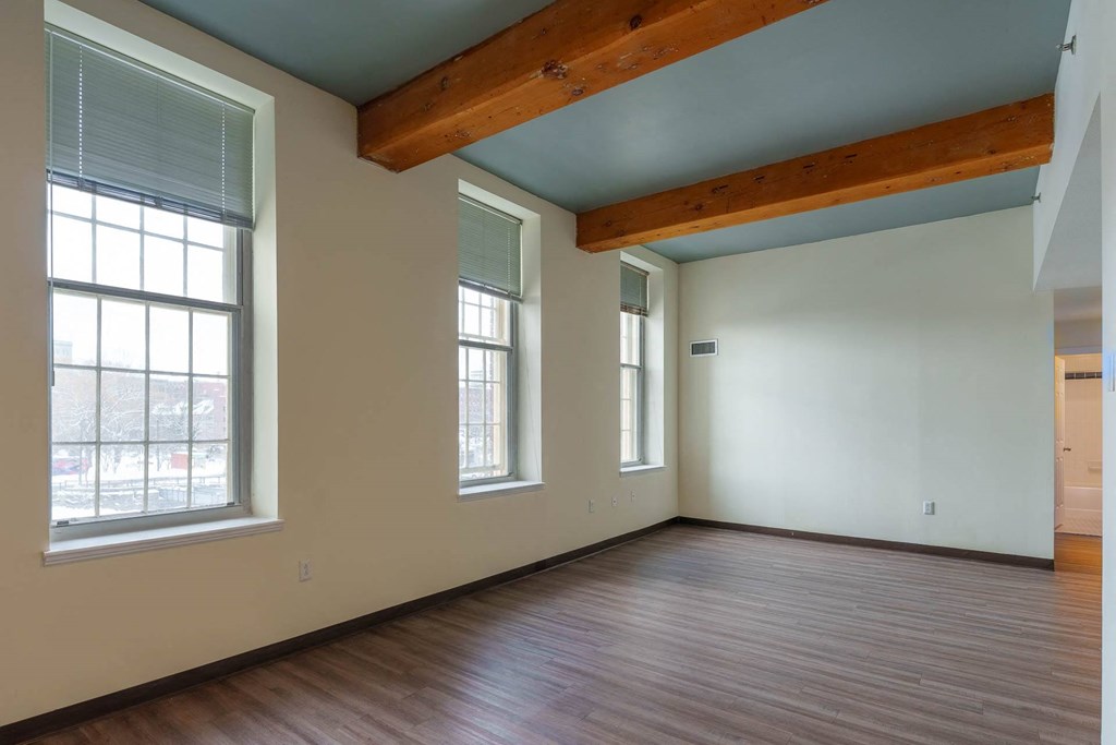 A room with wooden floors and a window.