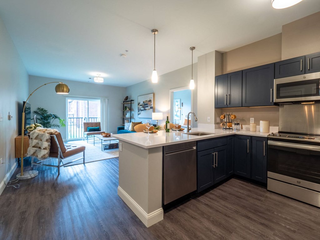 Another angle of a spacious kitchen showcasing an open layout with views into the living and dining areas.