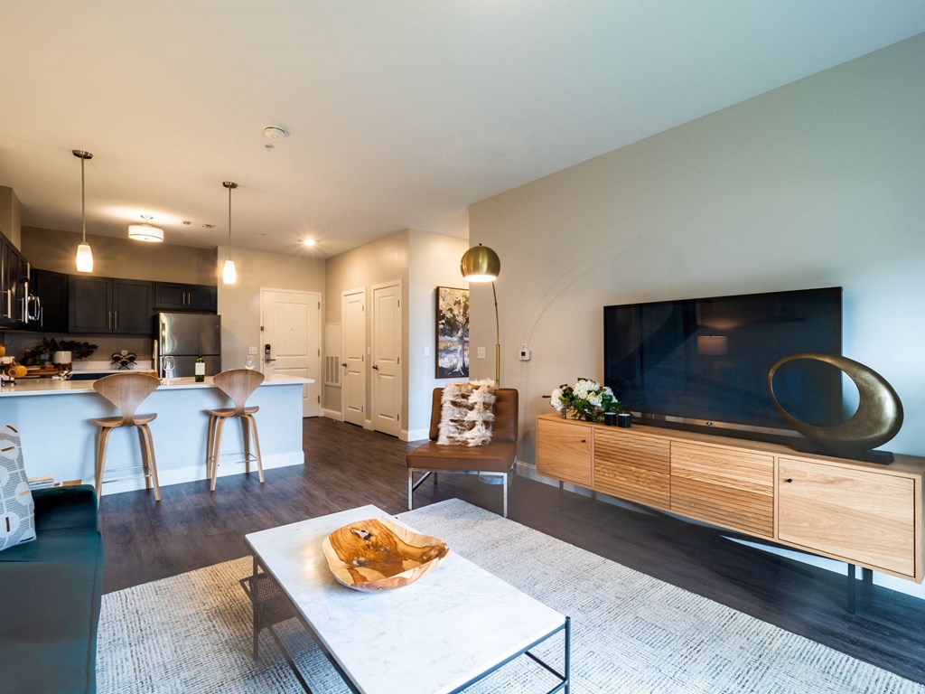 A contemporary living area with a stylish layout, featuring a modern couch, a chic coffee table, and elegant lighting.