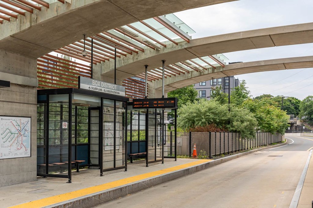 A bus stop with a sign that reads