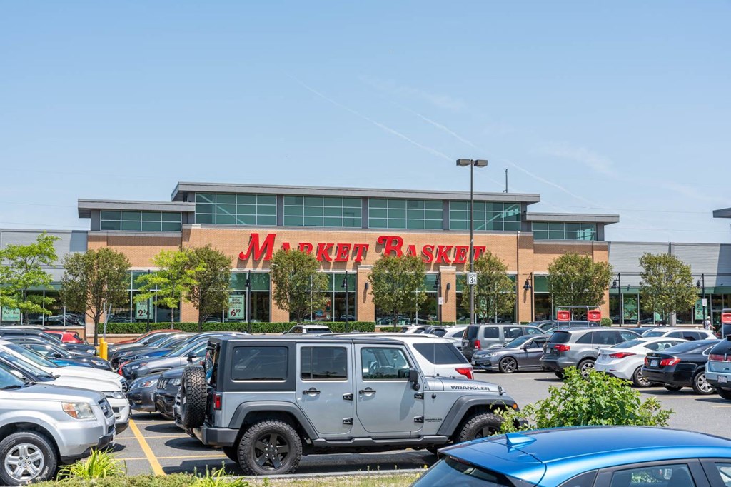 Cars parked in a lot in front of a Merrick's Basket store.