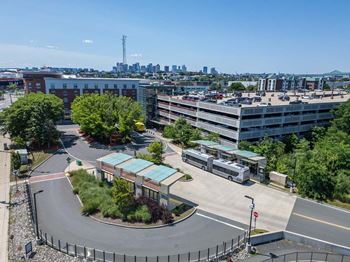 A parking lot with a building and a bus in front of it.