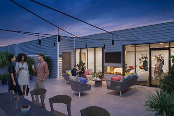 A group of people are gathered in a modern outdoor living space.