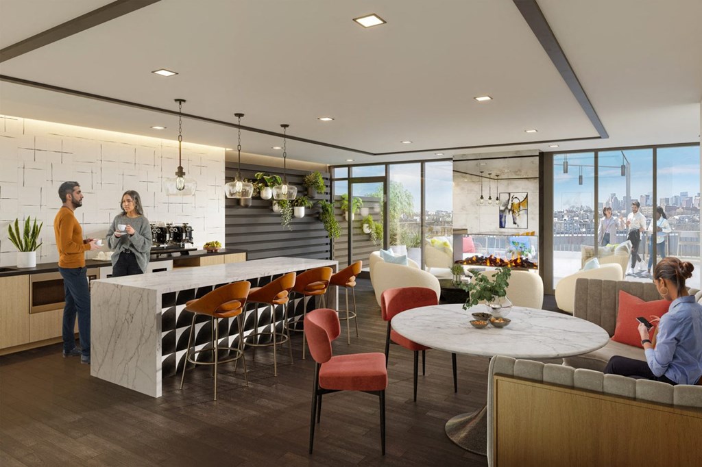A modern kitchen and dining area with people socializing.