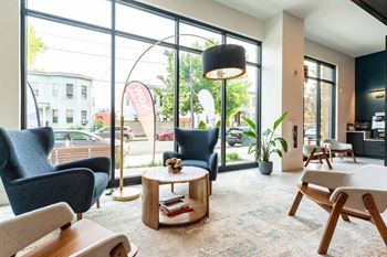 A waiting area with comfortable seating and a view of the street outside.