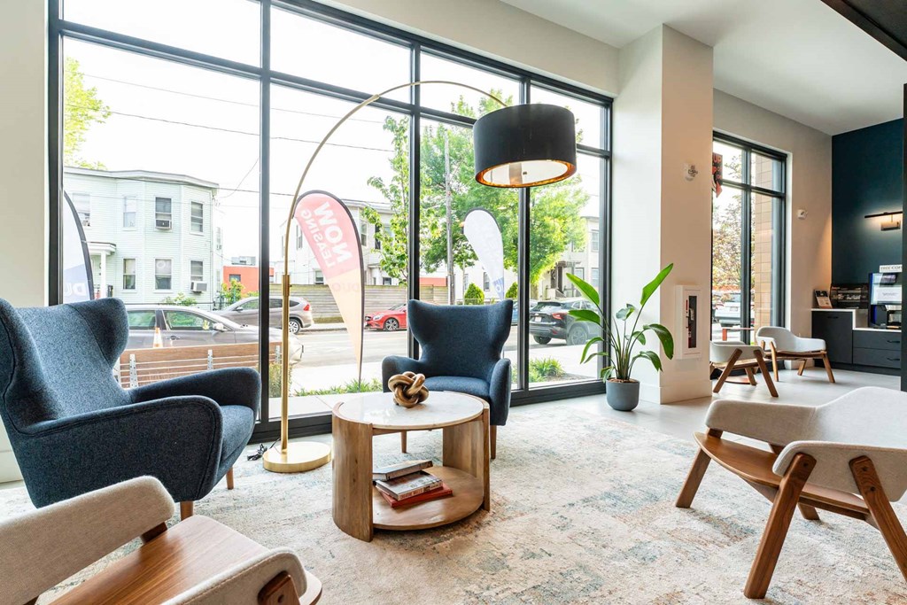 A waiting area with comfortable seating and a view of the street outside.