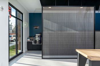 A room with a wooden table and a screen door.