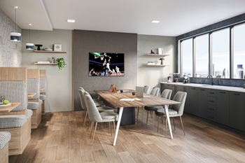 A modern kitchen with a dining table and chairs.