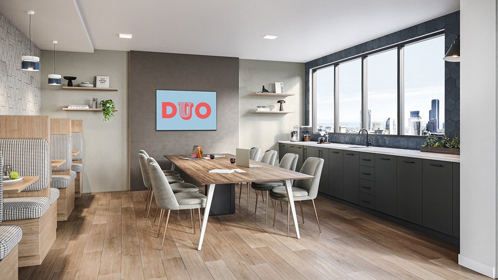 A modern kitchen with a dining table and chairs.