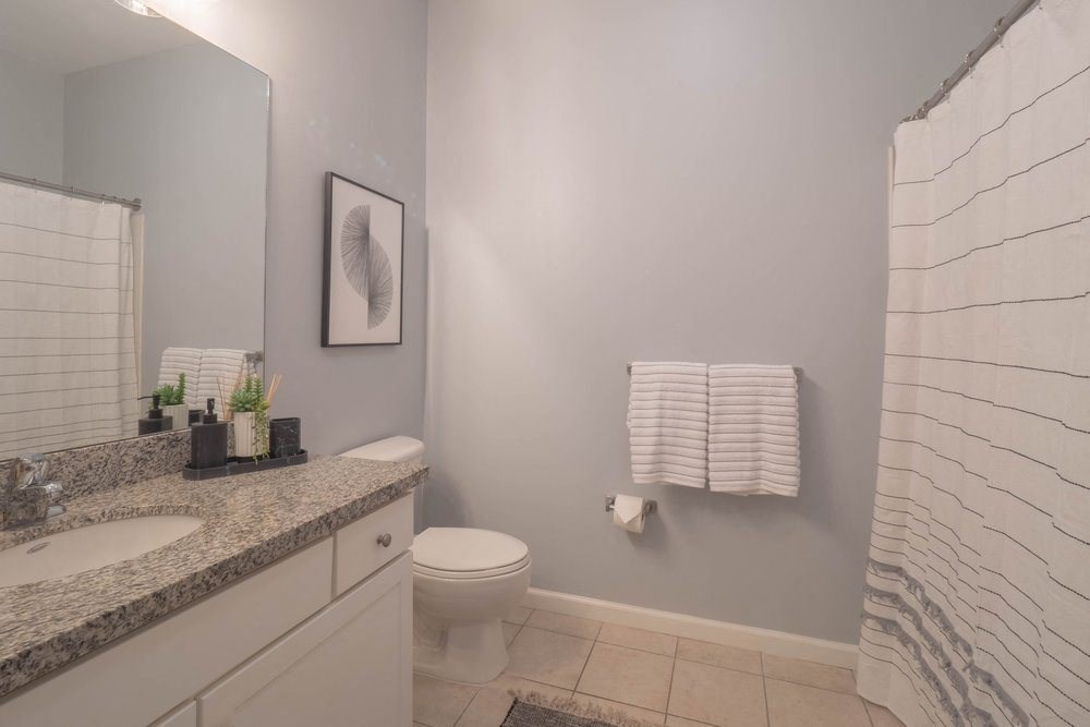 a bathroom with a toilet sink and shower