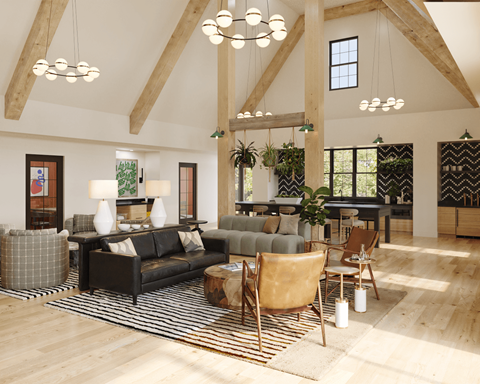 A living room with a black couch and a wooden floor.