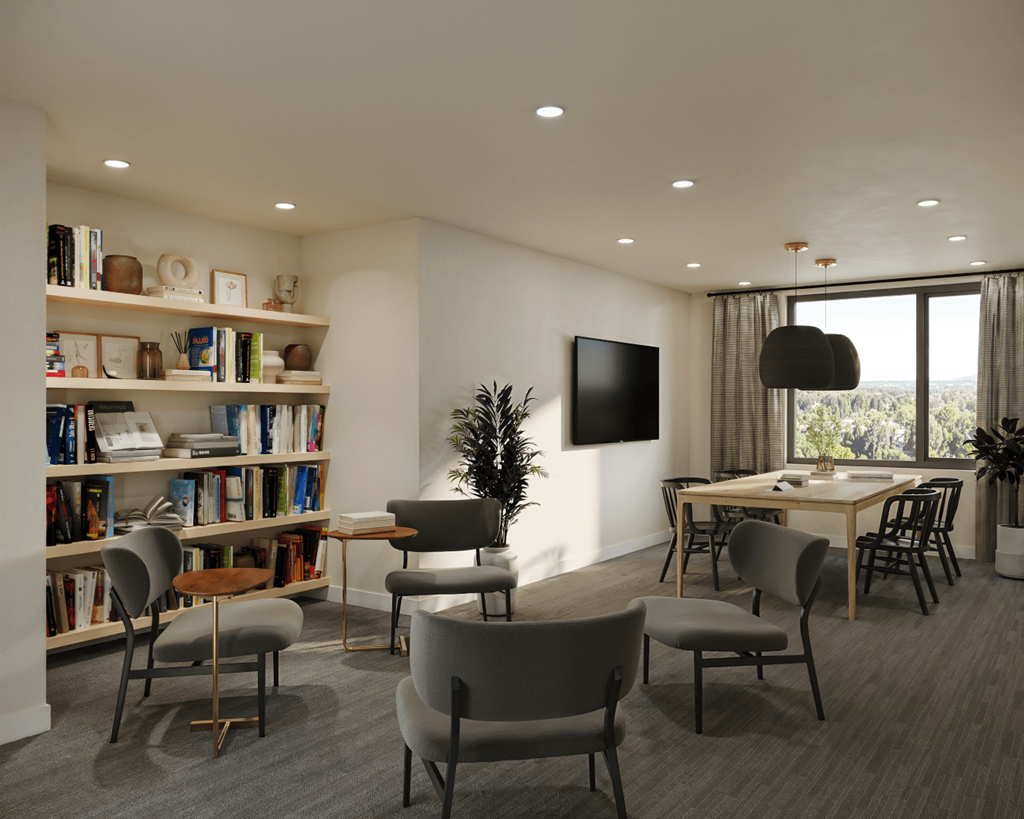 A modern living room with a large window, a bookshelf, and a dining table with chairs.