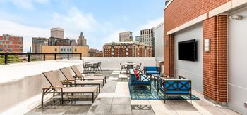 Rooftop deck with tv and views of city