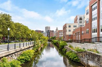 RI riverwalk with foliage and city skyline