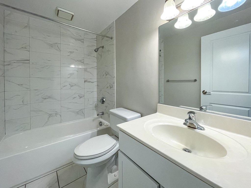 a bathroom with a sink toilet and bathtub